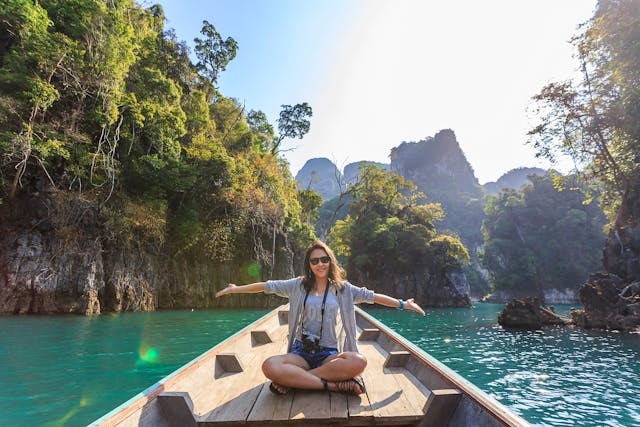 Lady on a dock at a lake as she travels for her online business