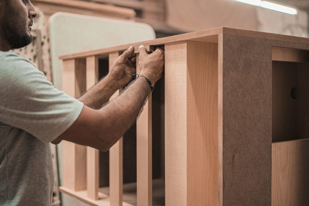 Man building a bed out of wood